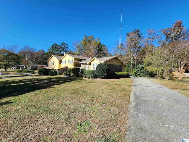 ranch-style home featuring a front yard