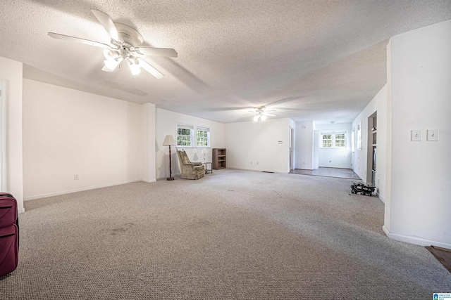 interior space featuring carpet flooring, ceiling fan, and a textured ceiling