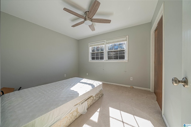 bedroom featuring ceiling fan, a closet, and light colored carpet