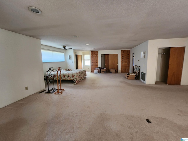 bedroom featuring carpet and a textured ceiling