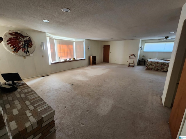 unfurnished living room featuring carpet floors and a textured ceiling