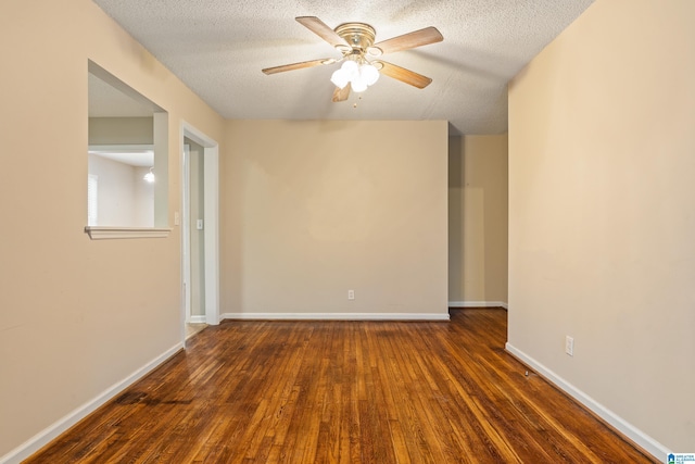 spare room with ceiling fan, dark wood-type flooring, and a textured ceiling