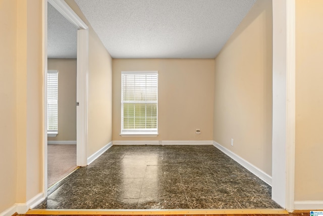 empty room with a textured ceiling