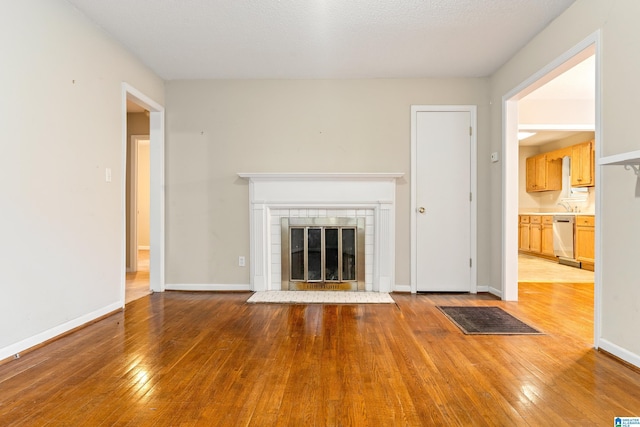 unfurnished living room featuring a fireplace and light hardwood / wood-style flooring