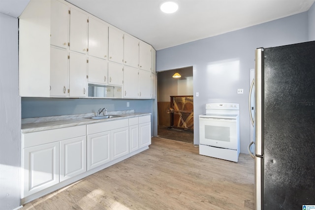 kitchen with stainless steel fridge, light wood-type flooring, white electric stove, and sink