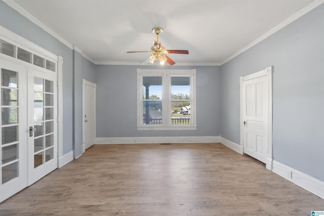 unfurnished room with ceiling fan, french doors, ornamental molding, and light wood-type flooring