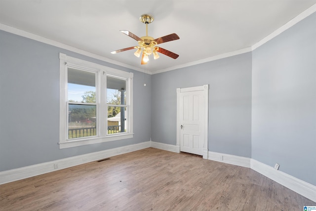 empty room with crown molding, ceiling fan, and wood-type flooring