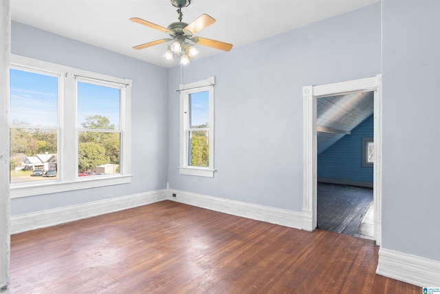 unfurnished room featuring lofted ceiling, ceiling fan, and dark wood-type flooring