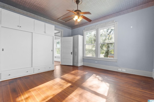 unfurnished bedroom with hardwood / wood-style floors and ceiling fan