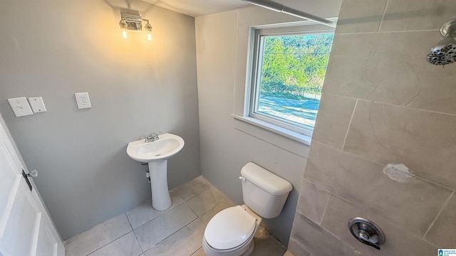 bathroom featuring toilet, tile patterned floors, and sink