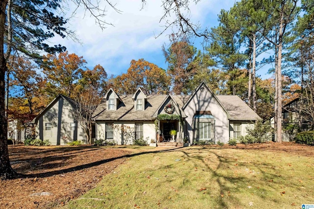 english style home featuring a front yard