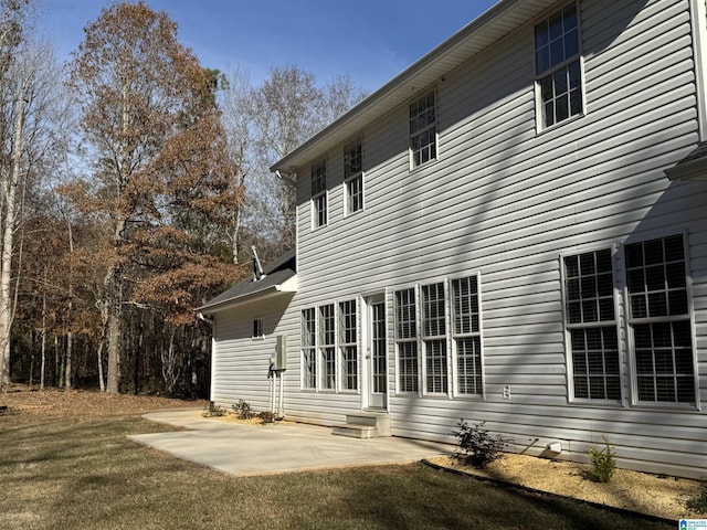 back of house featuring a patio and a lawn