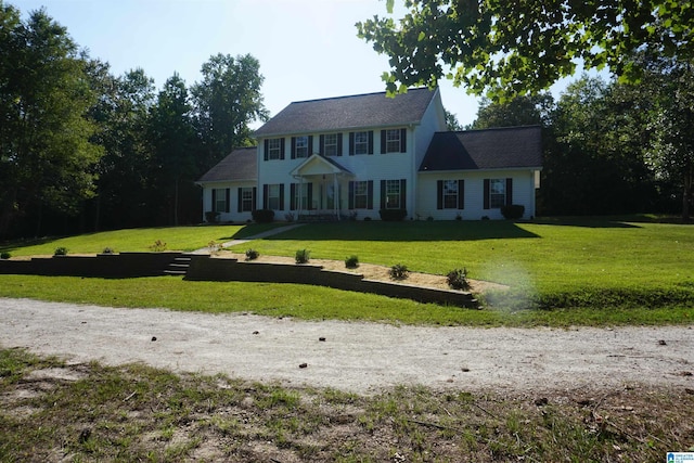 colonial inspired home with a front lawn