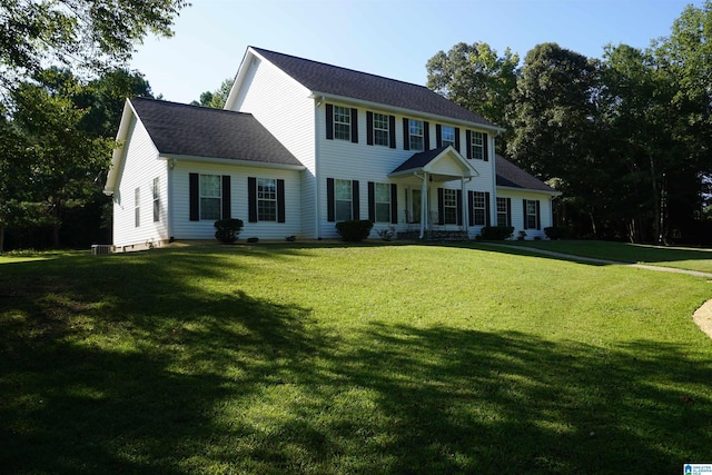 colonial inspired home featuring a front lawn