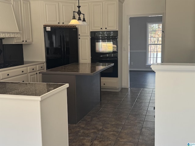 kitchen featuring custom exhaust hood, dark tile patterned floors, black appliances, pendant lighting, and a center island