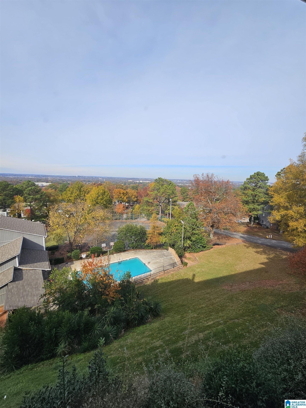 view of pool featuring a yard