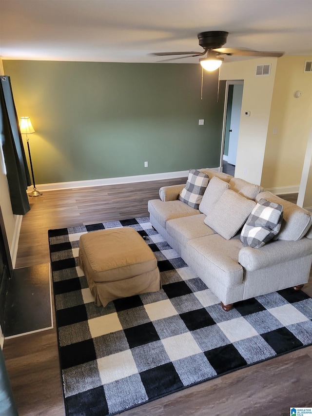 living room with wood-type flooring and ceiling fan