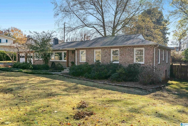 ranch-style home featuring a front yard