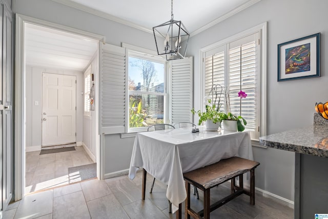 dining room with a notable chandelier and crown molding