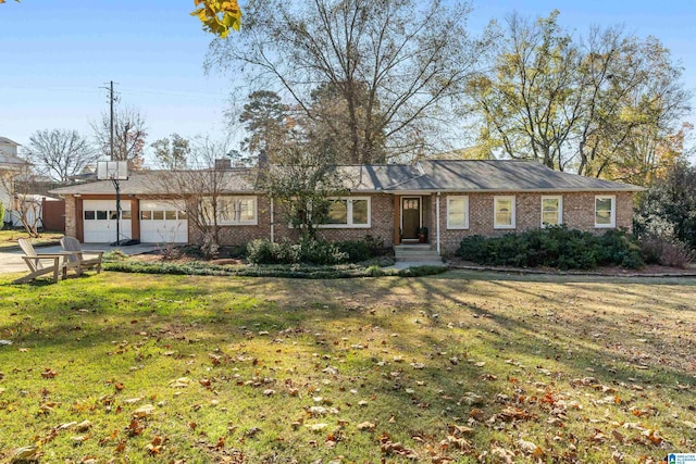 ranch-style house featuring a front yard and a garage