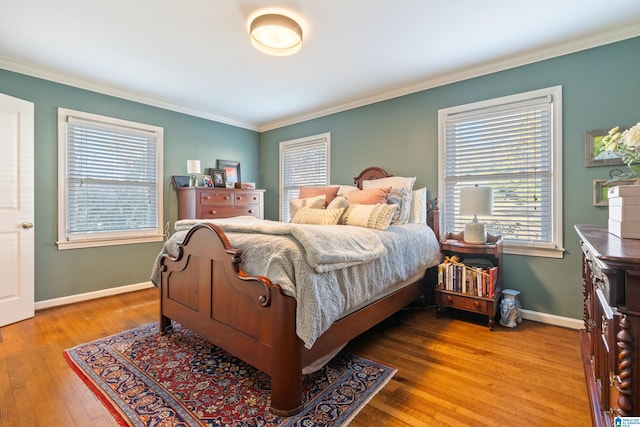 bedroom with wood-type flooring and ornamental molding