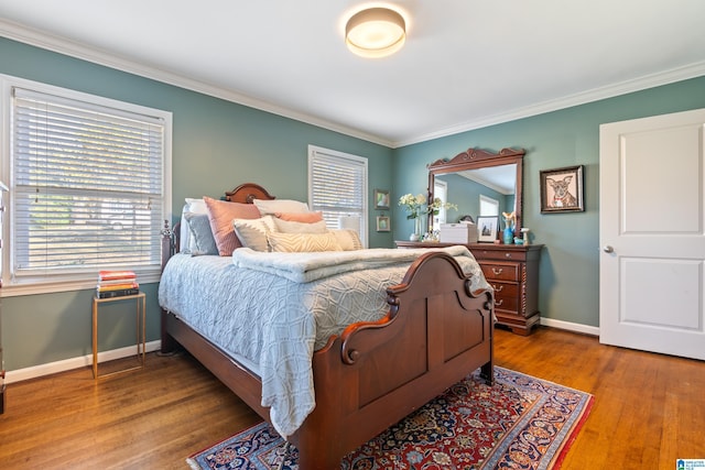 bedroom with crown molding and hardwood / wood-style floors