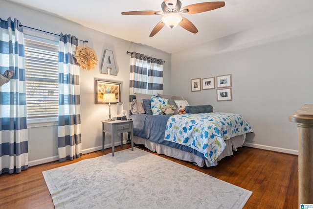 bedroom with dark hardwood / wood-style floors and ceiling fan