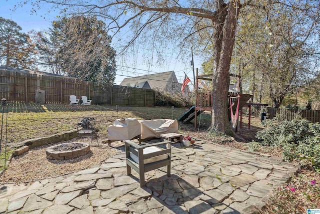 view of patio / terrace featuring a playground and a fire pit