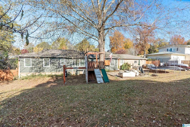 view of yard featuring a playground and a trampoline