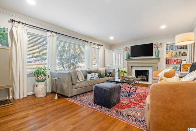 living room with hardwood / wood-style floors and ornamental molding