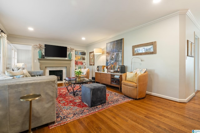 living room with hardwood / wood-style floors and ornamental molding