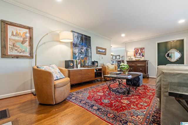 living room with crown molding and wood-type flooring