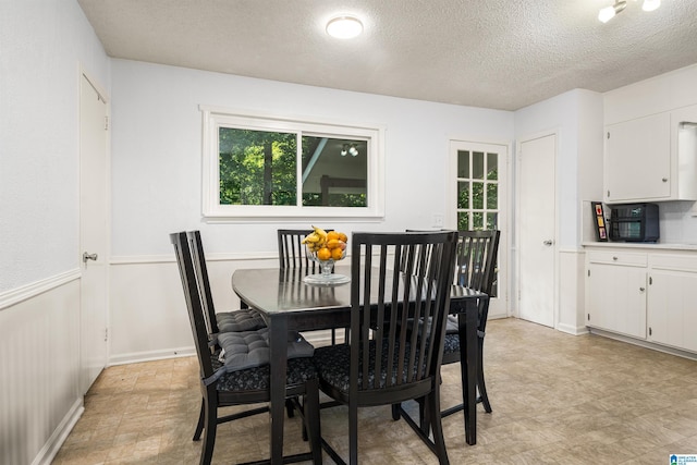 dining area featuring a textured ceiling