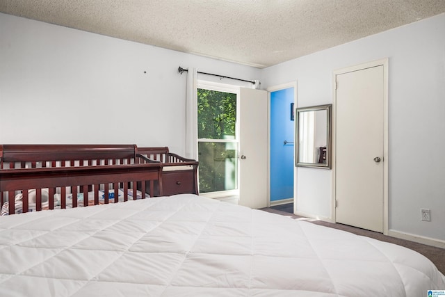 carpeted bedroom featuring a textured ceiling