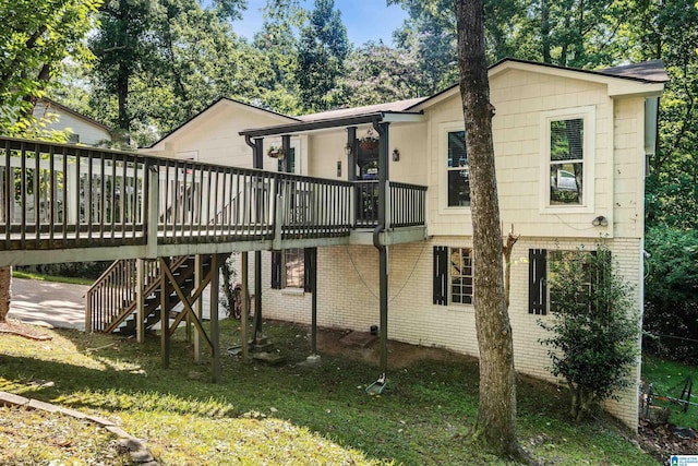 back of house featuring a yard and a wooden deck