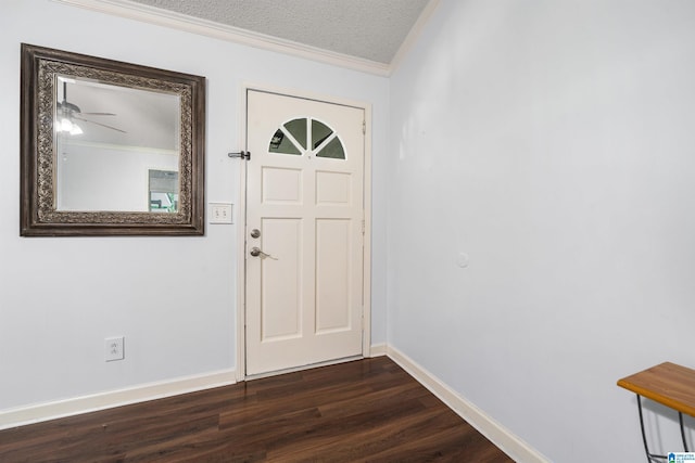 foyer entrance with ornamental molding, a textured ceiling, ceiling fan, and dark wood-type flooring