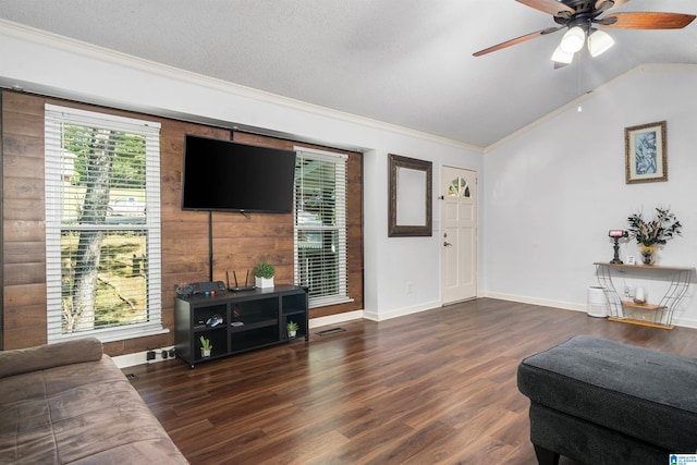 living room featuring ceiling fan, dark wood-type flooring, crown molding, a textured ceiling, and lofted ceiling