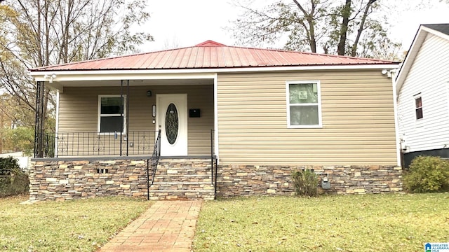 1245 16th St SW, Birmingham, AL 35211 - view of front of house featuring a front lawn, covered porch, and metal roof