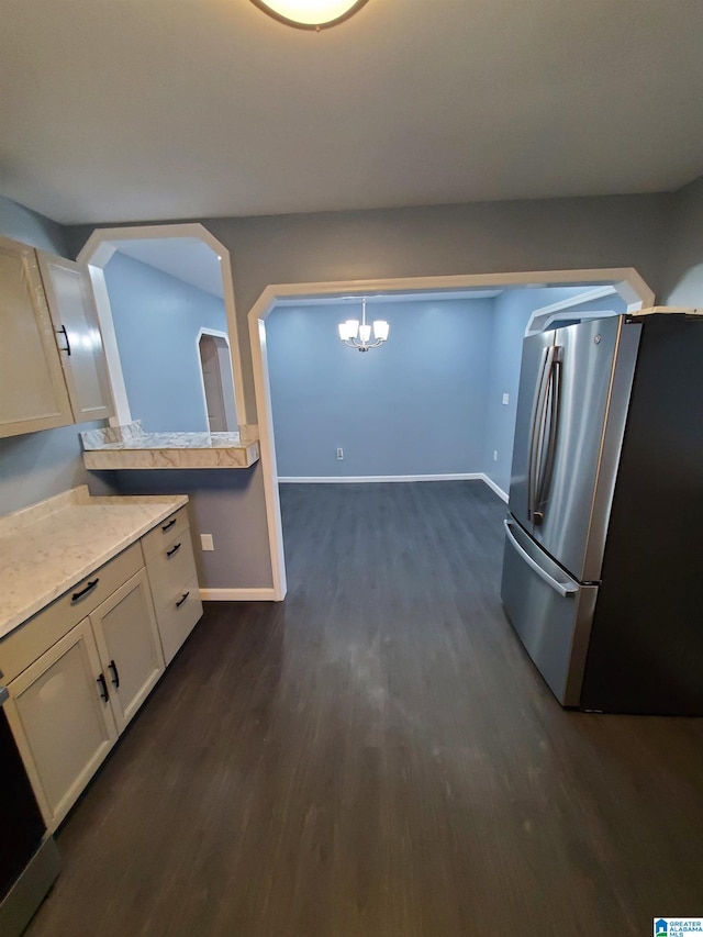 1245 16th St SW, Birmingham, AL 35211 - kitchen with freestanding refrigerator, dark wood finished floors, a chandelier, light countertops, and baseboards