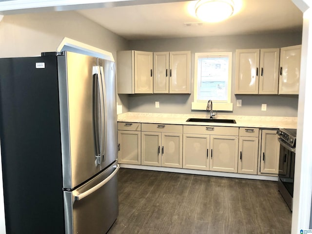 kitchen featuring stainless steel fridge, dark hardwood / wood-style flooring, sink, and black range with electric cooktop