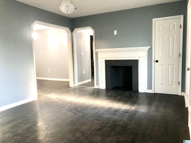 unfurnished living room featuring dark hardwood / wood-style floors and a fireplace