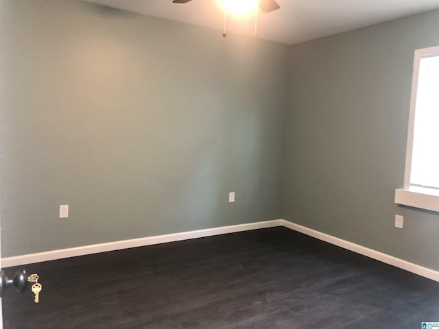 unfurnished room with dark hardwood / wood-style flooring, a wealth of natural light, and ceiling fan