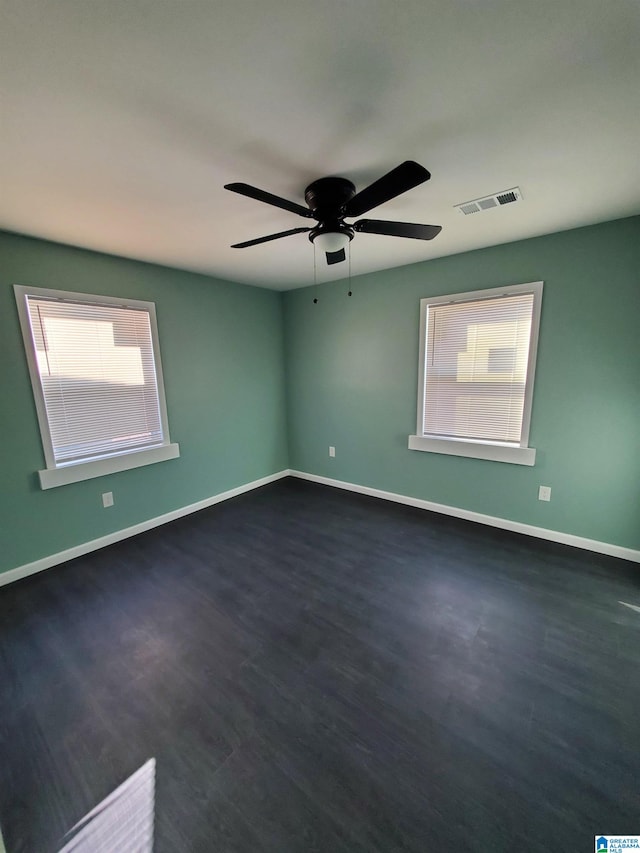 1245 16th St SW, Birmingham, AL 35211 - spare room featuring baseboards, dark wood-style flooring, and a ceiling fan