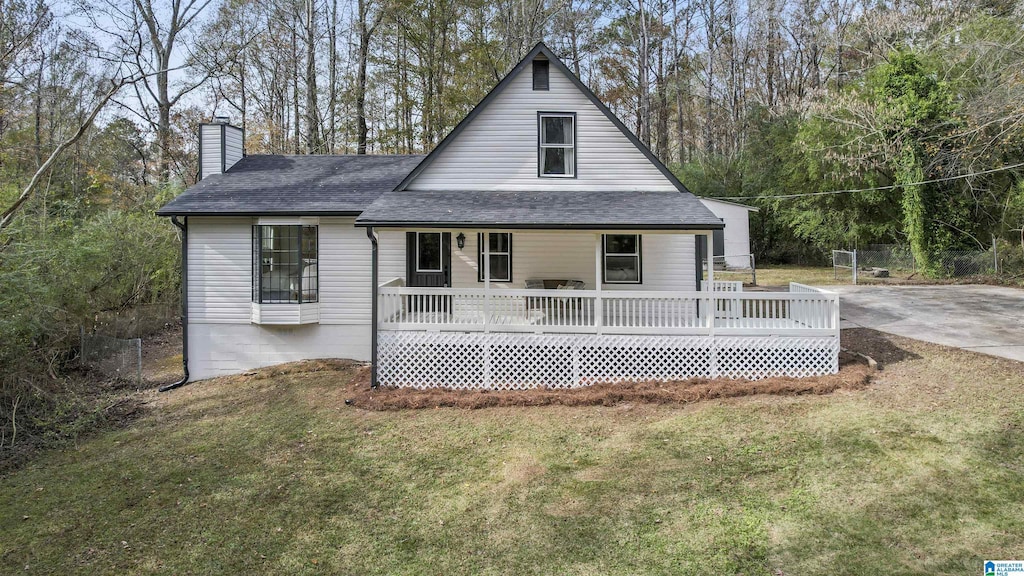 rear view of house featuring a yard