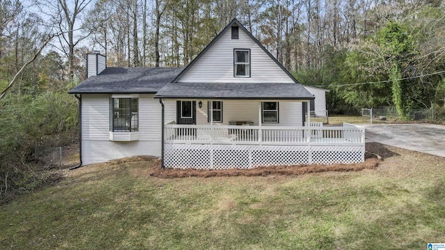 rear view of house featuring a yard