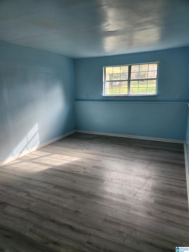 unfurnished room with dark hardwood / wood-style flooring