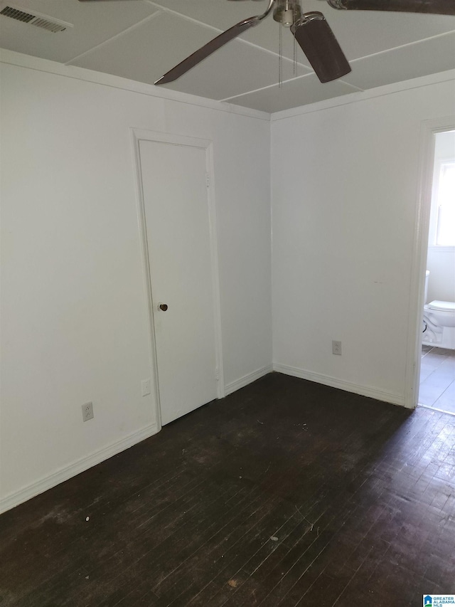 spare room with dark hardwood / wood-style floors and ceiling fan