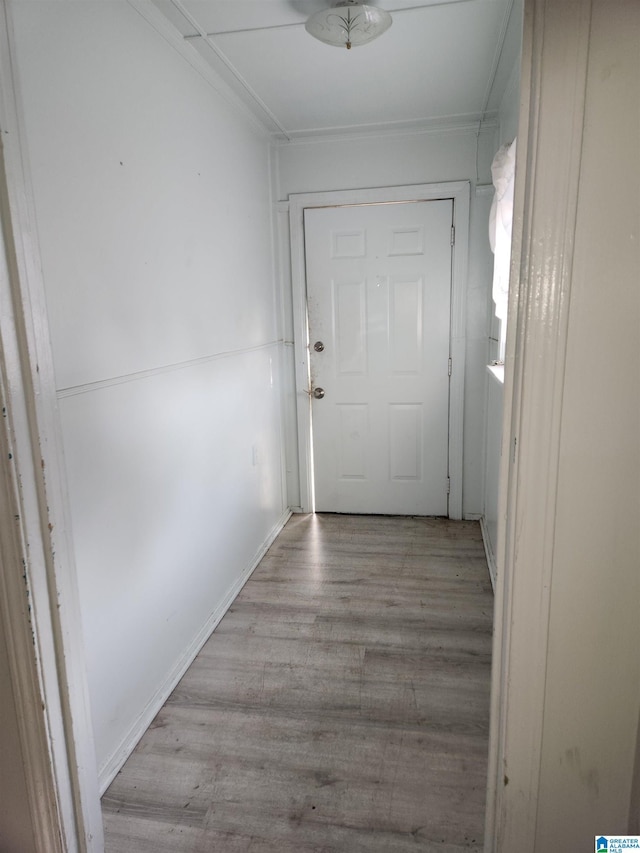 corridor with light hardwood / wood-style floors