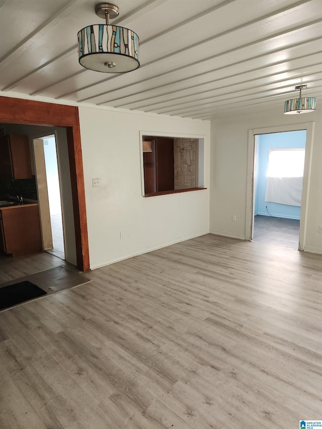 interior space featuring beam ceiling and hardwood / wood-style flooring