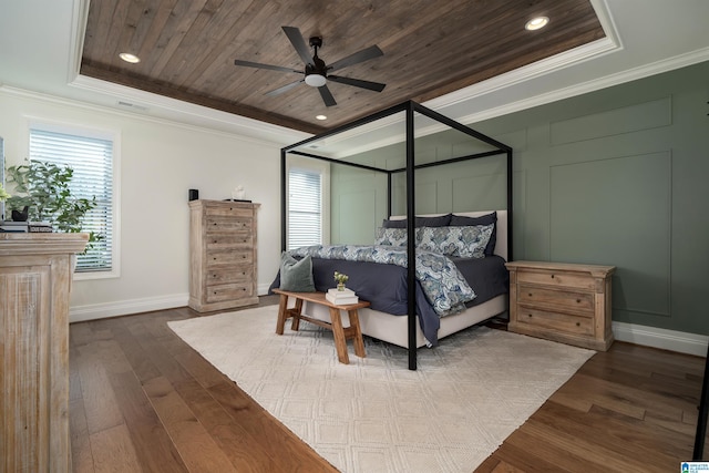 bedroom with ornamental molding, wood ceiling, a tray ceiling, ceiling fan, and hardwood / wood-style floors